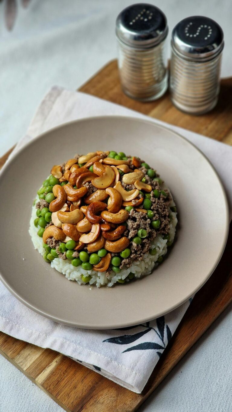 A savory dish of mushroom, peas, and cashew rice pilaf served elegantly.